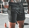 Black athletic shorts with side pocket, drawstring waist, and fitted design for active wear