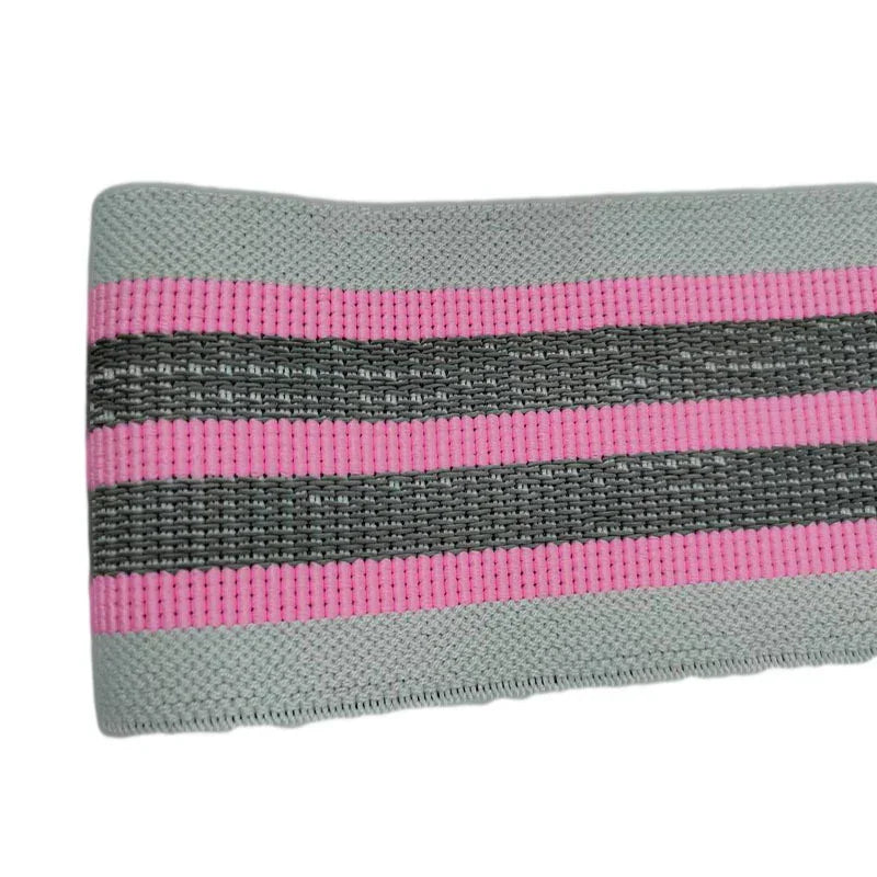 Close-up of a stretch fabric band in grey with pink and black stripes, ribbed texture