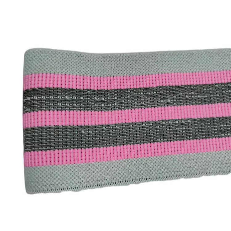 Close-up of a stretch fabric band in grey with pink and black stripes, ribbed texture