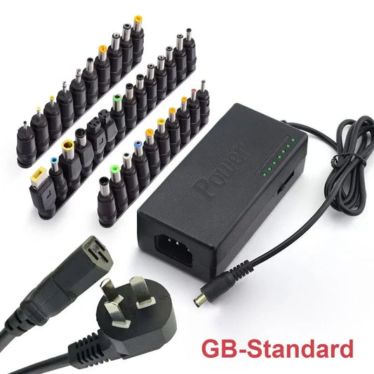 Universal laptop charger with UK plug, multiple interchangeable black power tips.