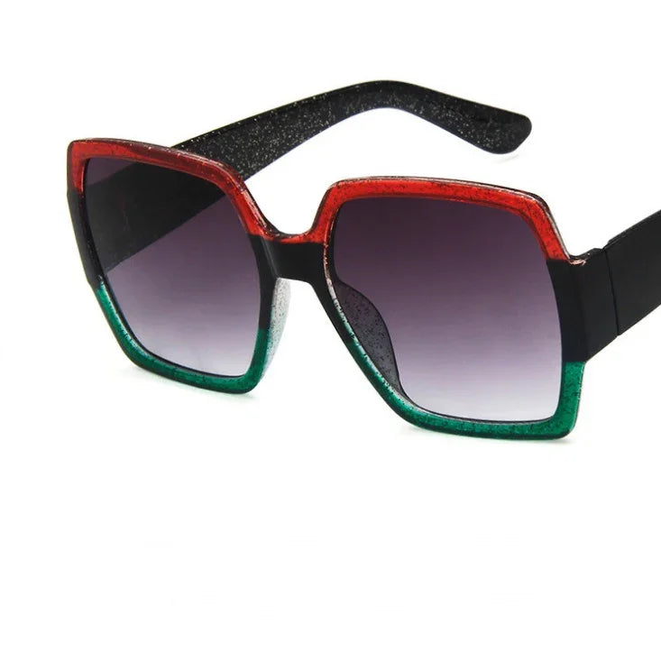 Square oversized sunglasses with red and green gradient frame, black arms, and tinted lenses.