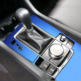 Blue metallic car center console cover with gear shift and black leather detailing
