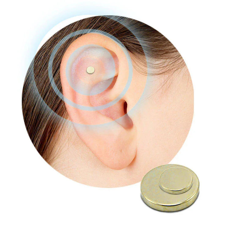 Gold magnetic ear stud on ear, metallic finish, minimalistic non-piercing accessory.