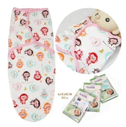 Colorful monkey print cotton swaddle blanket with pink trim, soft and breathable fit.