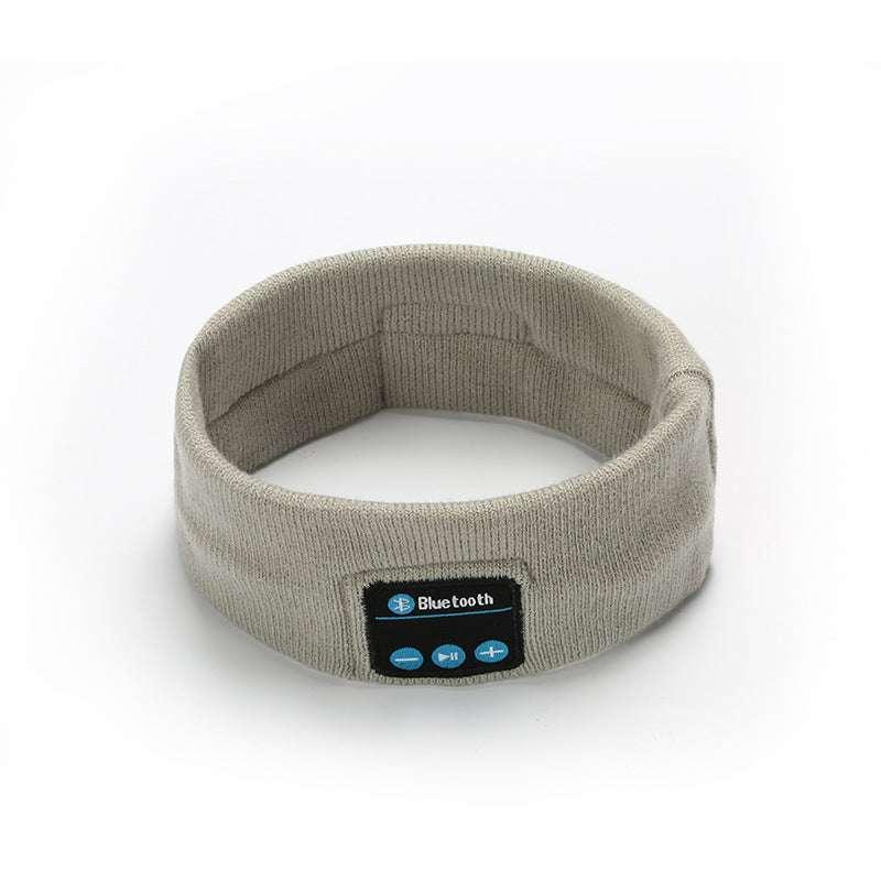 Beige knit wireless Bluetooth headband with built-in controls, modern tech accessory.
