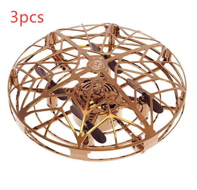 Rose gold cage drone with black propellers, futuristic tech gadget, round protective shell