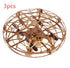 Rose gold cage drone with black propellers, futuristic tech gadget, round protective shell