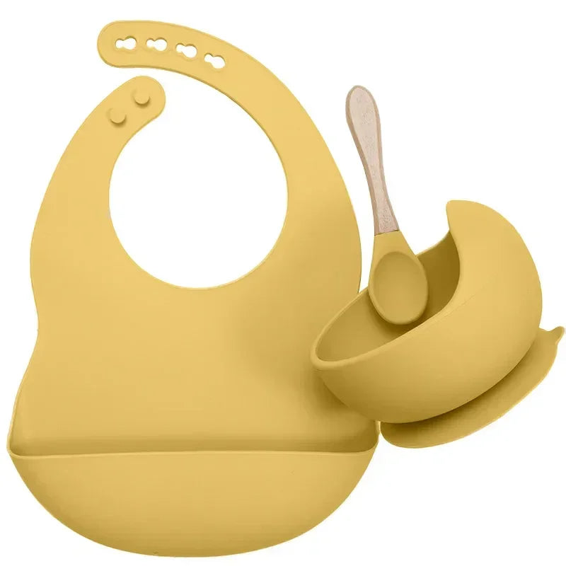 Yellow silicone bib, bowl, and spoon set for babies, adjustable fit, soft material