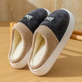 Cozy slip-on slippers with ribbed tan and dark gray fabric, plush fleece lining, and thick soles