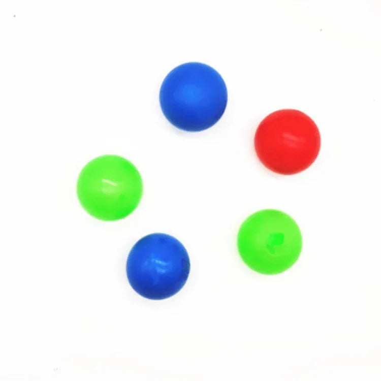 Colorful plastic balls in blue, green, and red arranged on a white background.
