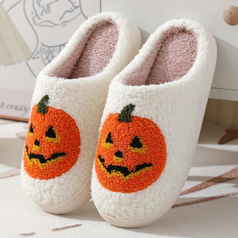 White fuzzy slippers with orange pumpkin face embroidery, cozy indoor footwear, relaxed fit