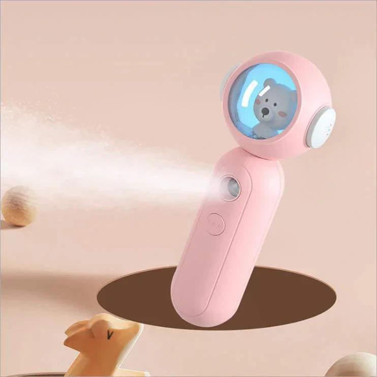 Pink handheld mini fan and mister with cute bear design and soft matte finish