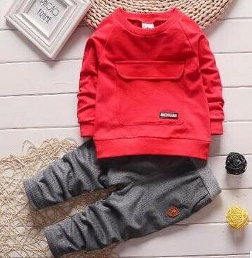 Red long-sleeve sweatshirt and gray jogger pants set, cotton, relaxed fit, modern streetwear style.