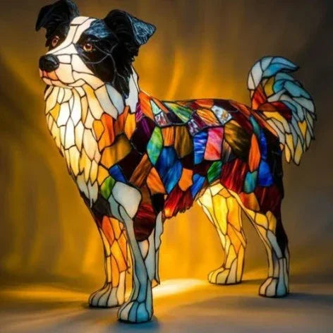 Colorful stained glass dog-shaped lamp with patchwork pattern illuminated, standing on a surface.