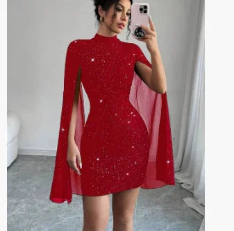 Woman wearing a fitted red glitter mini dress with cape sleeves in a modern room