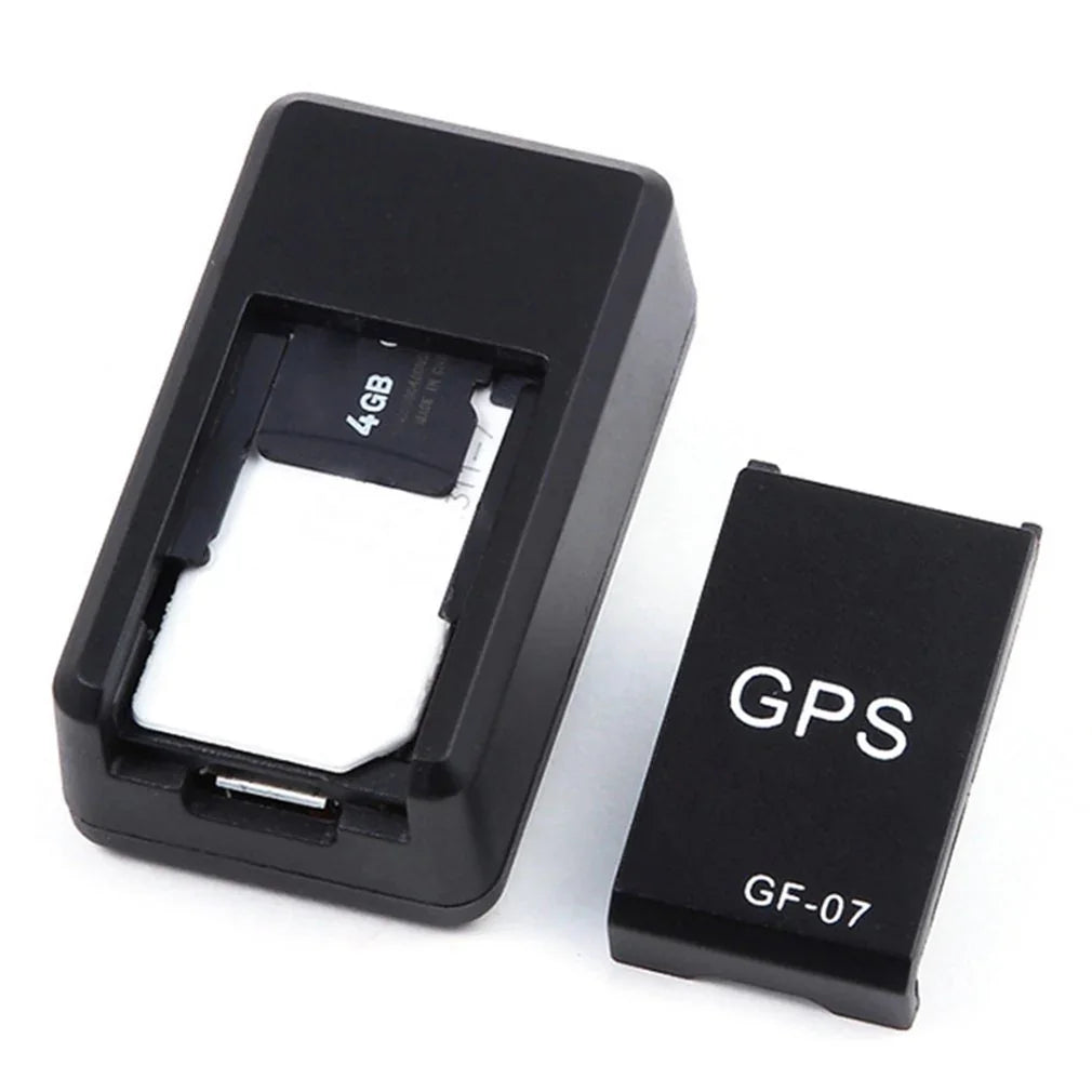 Black compact GPS tracker device with removable cover and visible 4GB memory card.