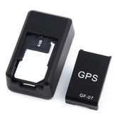 Black compact GPS tracker device with removable cover and visible 4GB memory card.