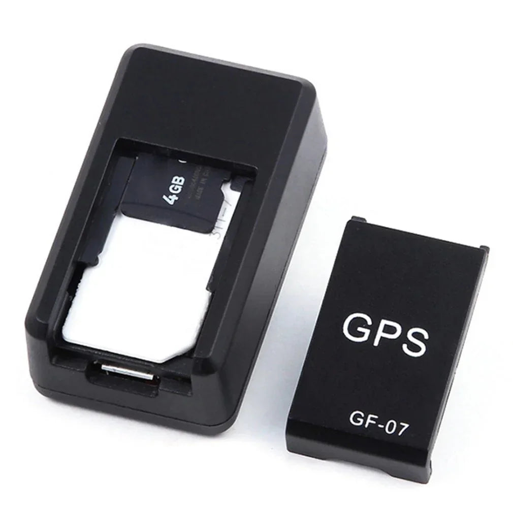 Black compact GPS tracker device with removable cover and visible 4GB memory card.