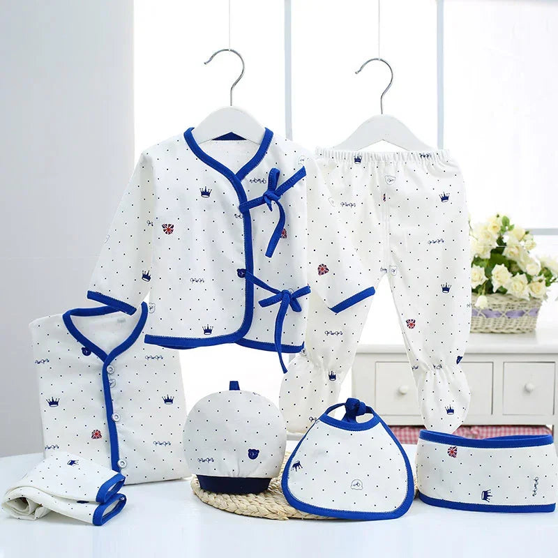 White baby clothing set with blue trim, soft cotton, polka dot and crown print, relaxed fit.