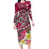 Woman wearing fitted long sleeve midi dress with vibrant pink floral and tribal print