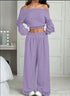 Woman wearing a lilac off-shoulder knit crop top and wide-leg lounge pants set