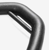 Close-up of black textured metal buckle with matte finish, minimal and modern design
