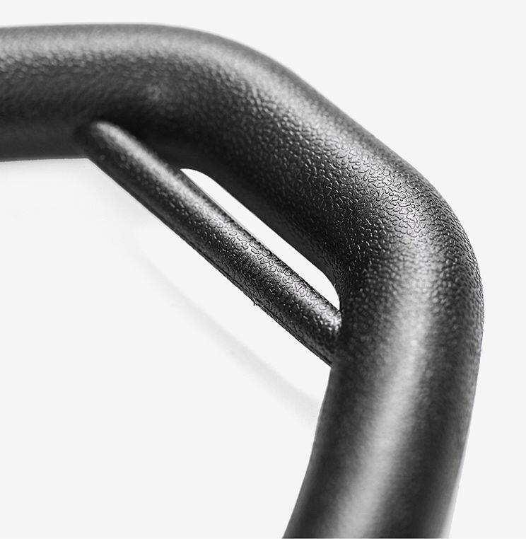 Close-up of black textured metal buckle with matte finish, minimal and modern design