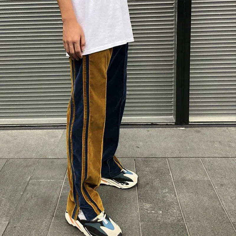 Loose fit colorblock pants in mustard yellow and navy velvet with contrast stitching.