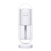 Minimalist white portable humidifier with cylindrical shape and transparent water tank