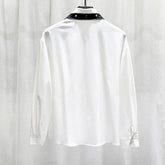 White long sleeve shirt with black snap collar, relaxed fit, satin-like fabric