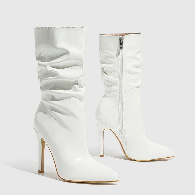 White patent leather slouchy knee-high boots with pointed toe and stiletto heel