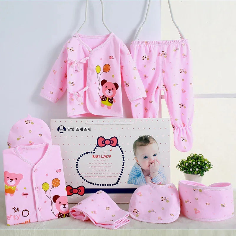 Pink baby clothing set with bear print, including long-sleeve top, pants, hat, and bibs, soft cotton material, relaxed fit.