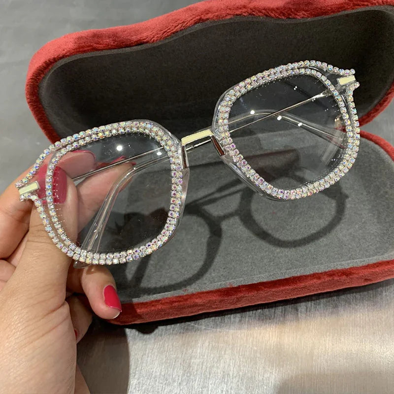 Square clear glasses with rhinestone trim and silver metal frame, displayed in red case