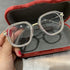 Square clear glasses with rhinestone trim and silver metal frame, displayed in red case