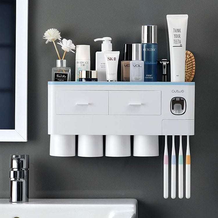 Modern white wall-mounted bathroom organizer with cups, toothbrushes, and toiletries on a grey wall.