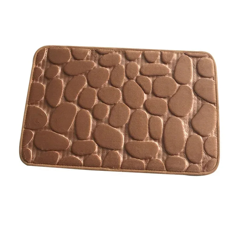 Brown rectangular bath mat with soft, raised pebble pattern and plush texture
