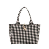Black and white checkered tote bag with fabric handles and rope button closure.