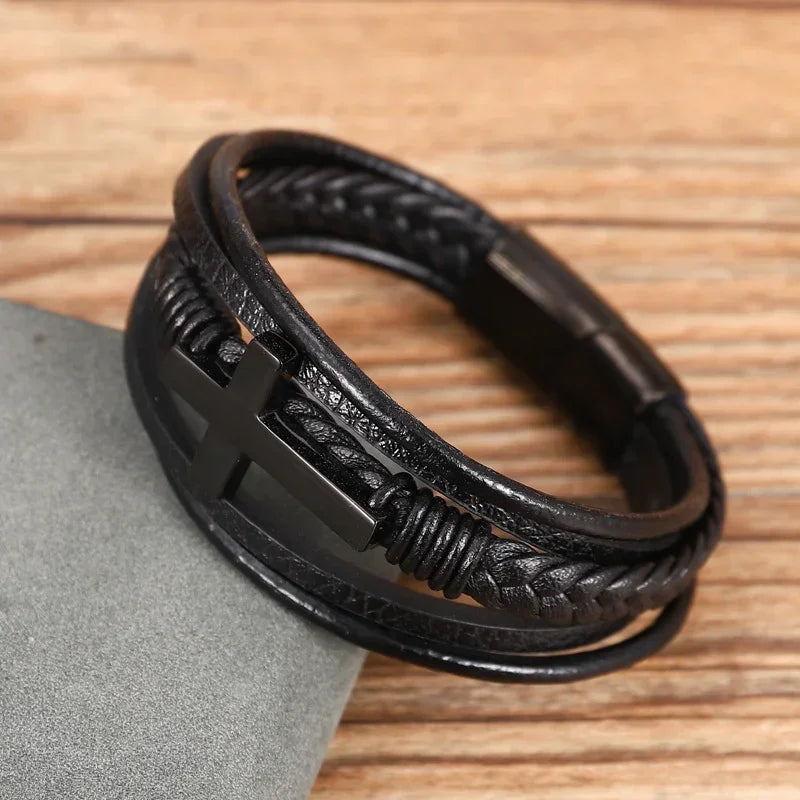 Black braided leather bracelet with metal cross accent and layered wrap style