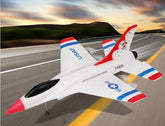 White toy jet airplane with red, blue, and black accents on a road background