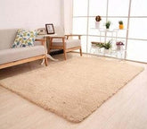 Beige shaggy area rug on light wood floor, modern minimalist living room decor
