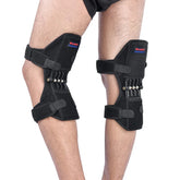 Adjustable black knee support braces with springs, worn for joint protection and ergonomic fit