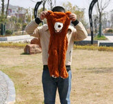Person holding up brown faux fur animal-themed hoodie outdoor, relaxed fit, playful style