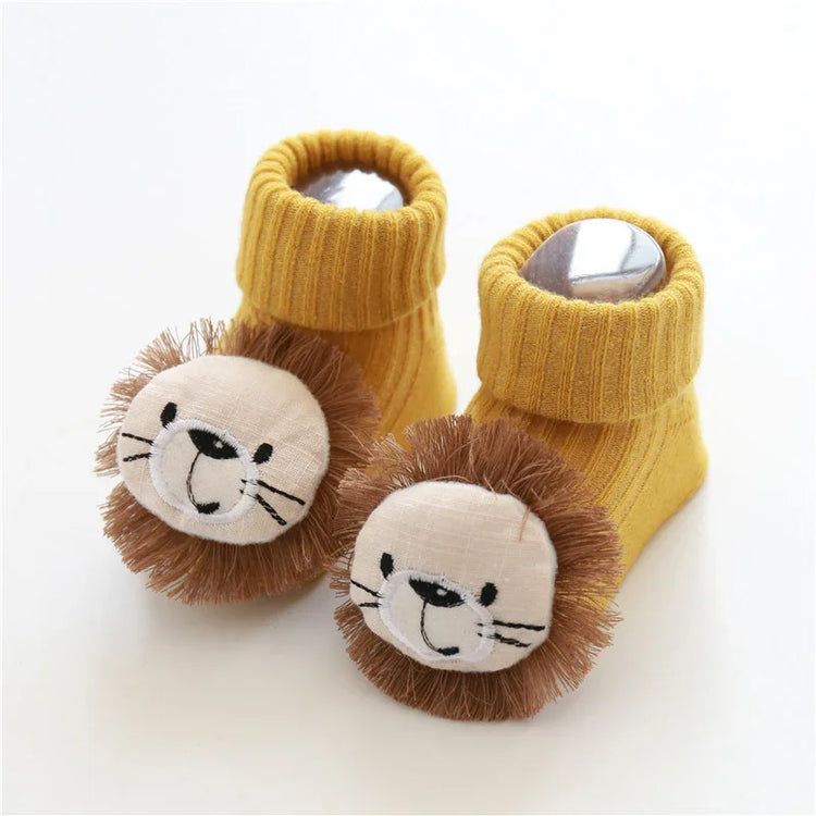 Yellow ribbed knit baby socks with plush lion face and brown mane, soft cozy fit