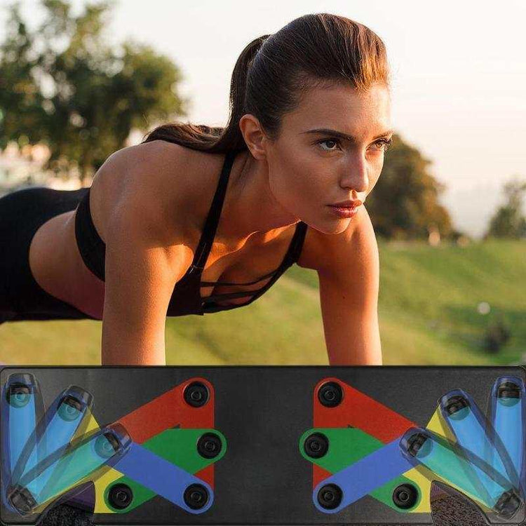 Woman in black sports bra doing workout outdoors, colorful push-up board in foreground