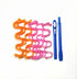 Curly orange and pink hair curlers with two blue plastic styling hooks on white background