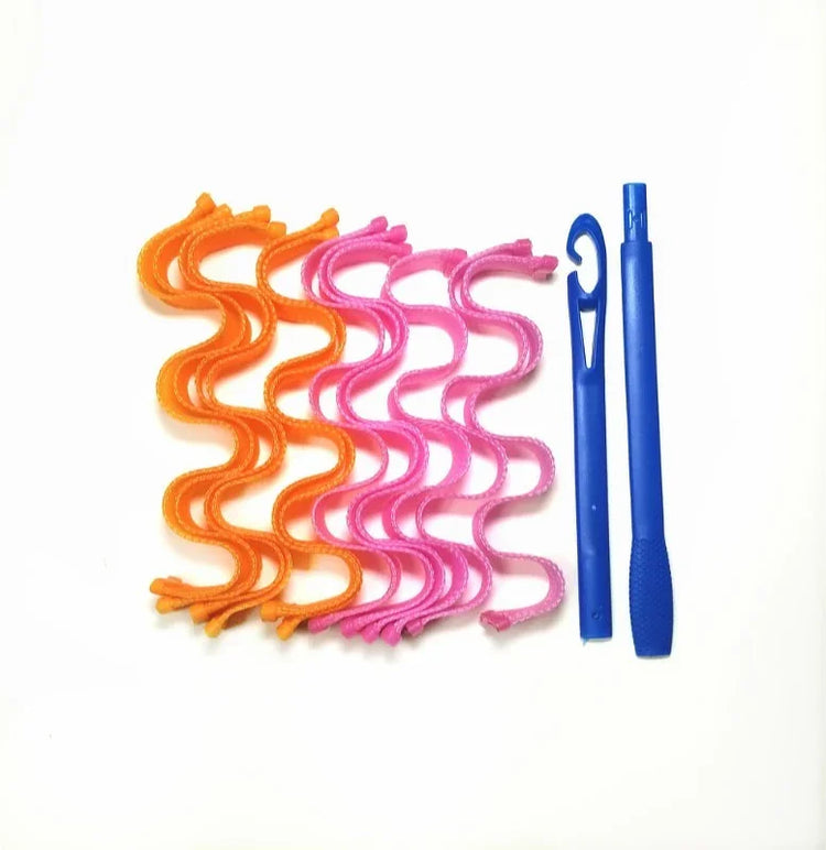 Curly orange and pink hair curlers with two blue plastic styling hooks on white background