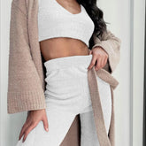 Woman in beige and white fuzzy loungewear set, relaxed fit, cozy textured fabric