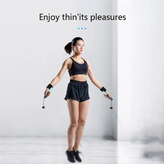 Woman jumping rope in black athletic crop top and loose high-waisted shorts, sporty fit