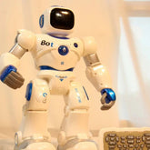 White and blue toy robot with glossy finish, standing next to a remote control on a light background.