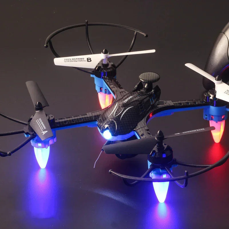 Black plastic quadcopter drone with LED lights and propeller guards on dark background